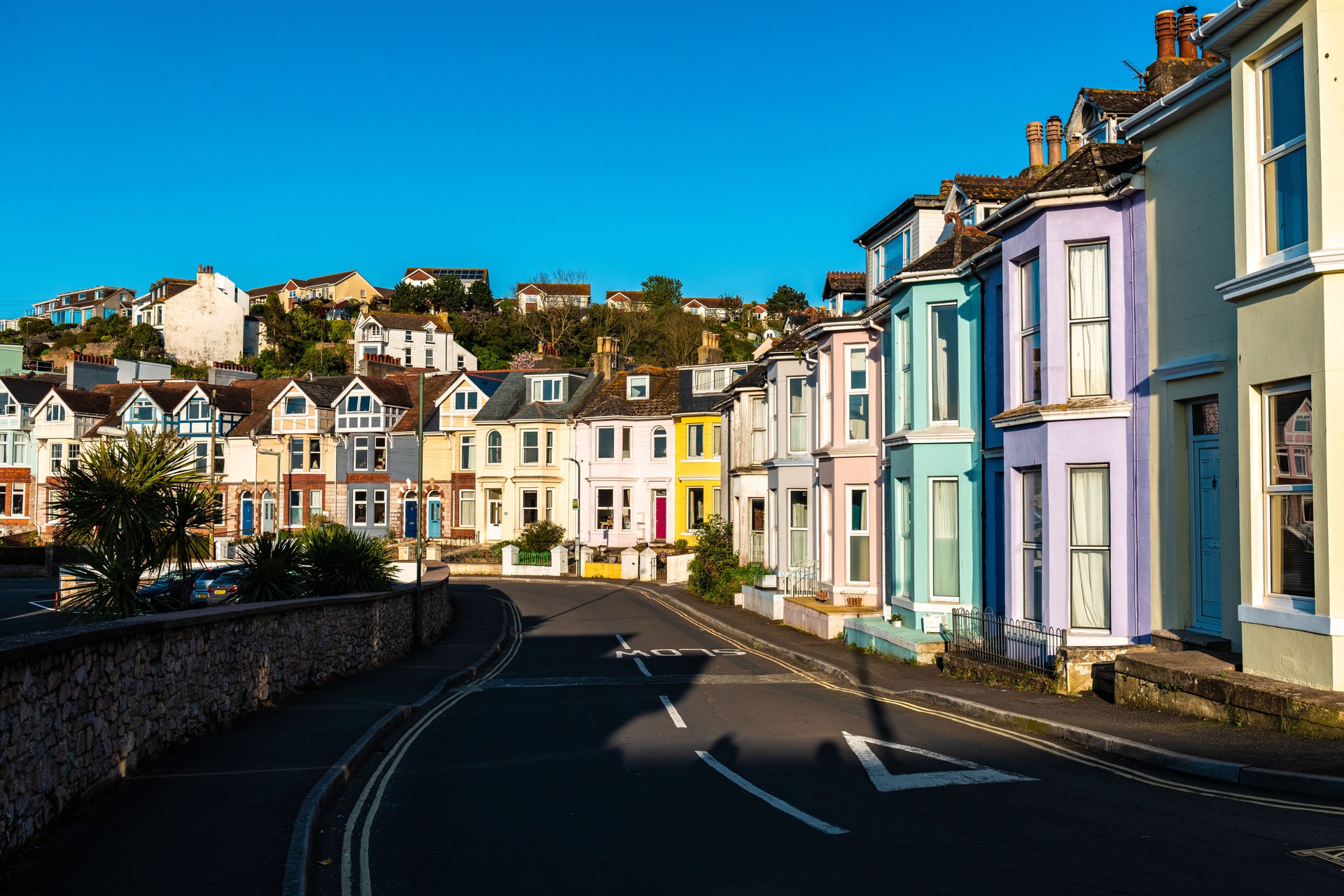 Colorful coastal houses on the hill in Brixham town in England